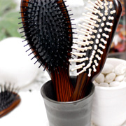 Wooden brush with special plastic blistles set in soft air cushion rubber base.